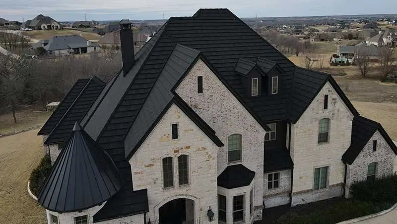 Example home with a stone-coated steel roof, turret and dormers